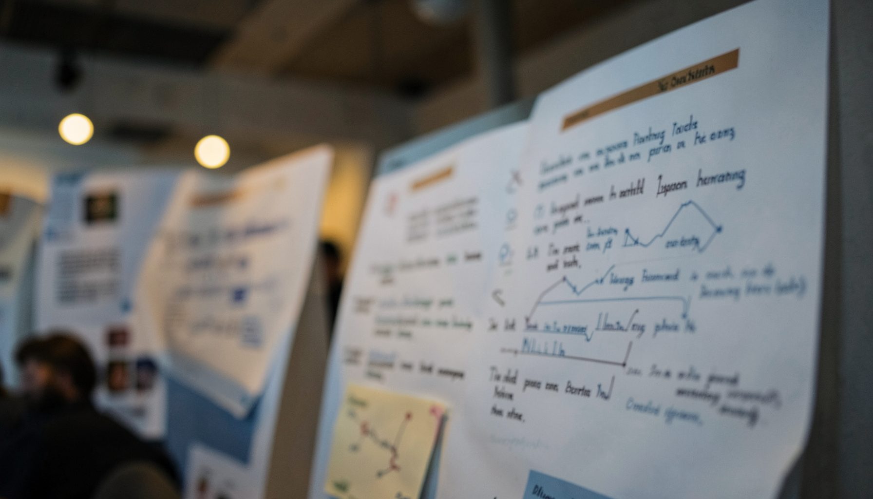 Abstract close-up of a scientific poster session, with muted blues and warm amber lighting suggesting a professional academic setting