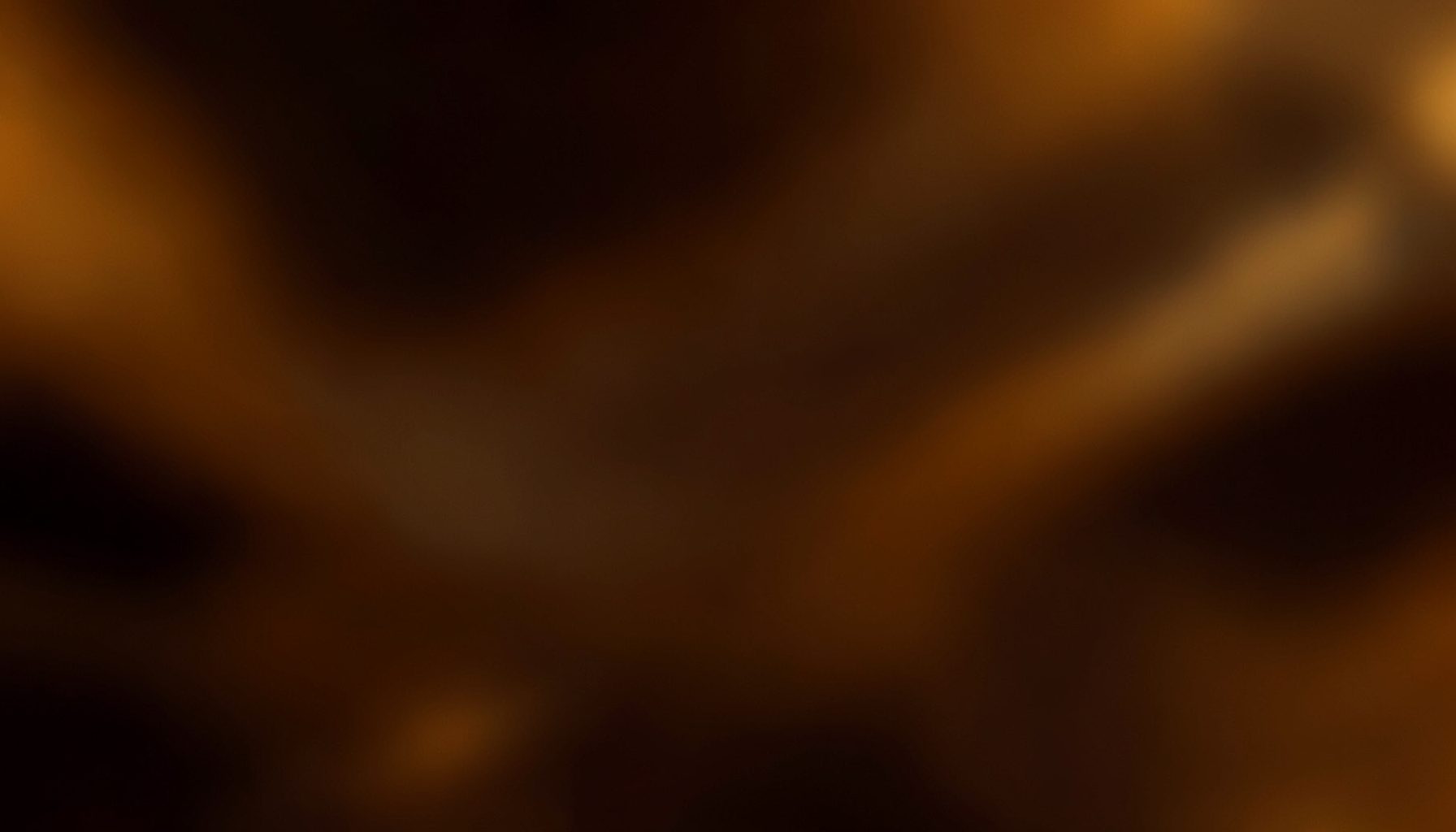 Warm abstract backdrop in deep brown and amber tones, suggesting a professional medical conference atmosphere with soft glowing highlights